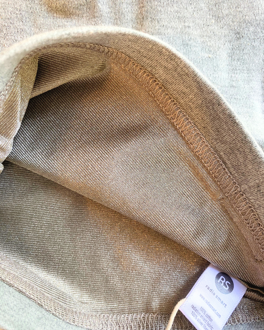 Protect your little one with the Radia Smart® Baby Hat Beanie, designed for ages 0–4 with three size options: Newborn, Baby, and Toddler. Made with silver-lined Faraday fabric, it offers EMF and RF blocking to reduce exposure to wireless radiation. Soft, breathable, and gentle on delicate skin, this beanie supports wellness and comfort for growing children. Ideal for everyday wear, it provides peace of mind with stylish, effective protection.